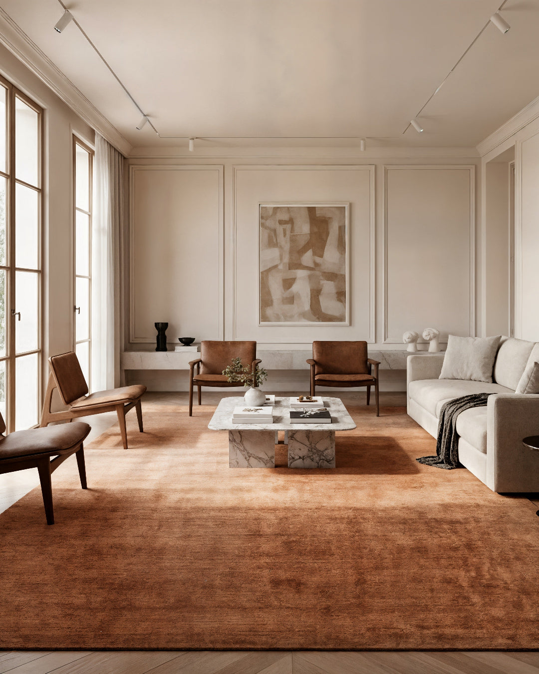 Modern living room with neutral tones, a rug, and furniture.